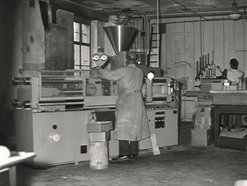 An old photo showing Utz employees operating injection molding machine