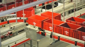 Containers moving on a conveyor belt in retail industry